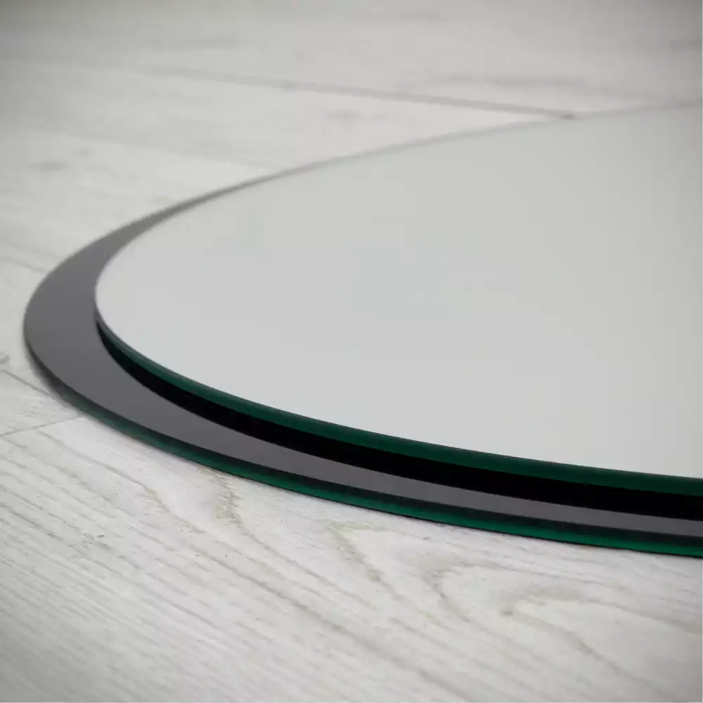 Miroir oval mur dans un cadre noir